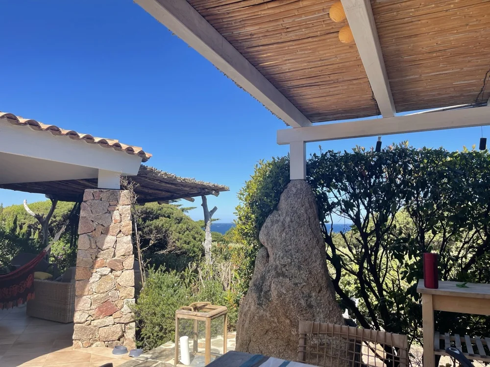Reed-shaded pergola with a glimpse of the sea