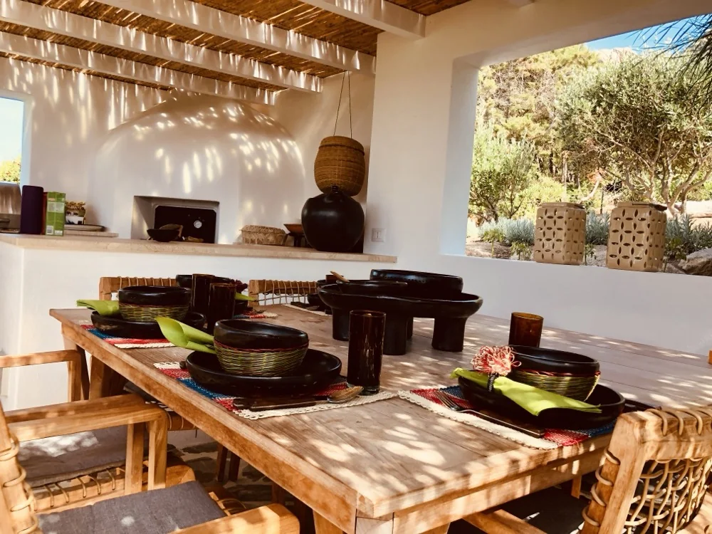 Outdoor kitchen and dining area in dappled shade